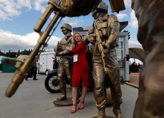 یک زن در کنار مجسمه های نظامی در مسکو