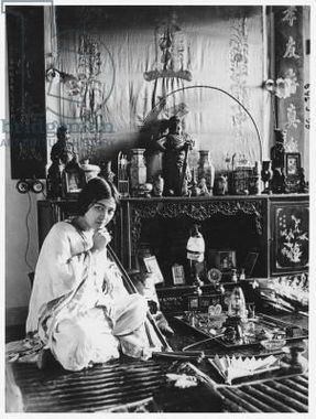 زن جوانی در حال کشیدن شیره تریاک در اوایل قرن ۲۰ میلادی